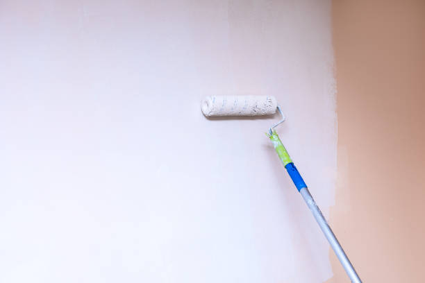 istock Painter use paint roller on wall with white stain. lifestyle close-up photo with copy sapce 1289784573