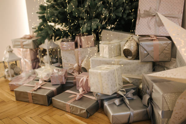 istock A lot of presents under Christmas tree. Beautiful packed different sizes presents at home by the Christmas tree 1289785311