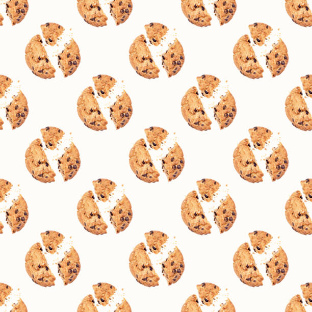 istock Top view of American chocolate chip cookie pieces with crumbs repeat seamless pattern on light background 1289786582