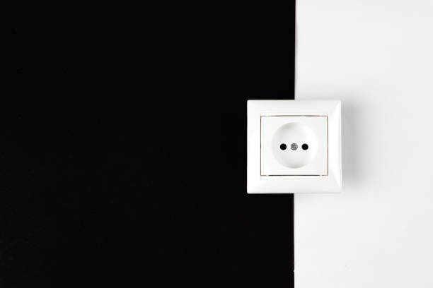 istock Night electricity rate. White socket on paper black and white background. 1289788764