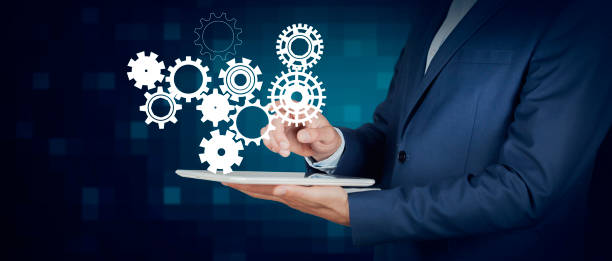 istock man holding gears in screen 1289789547