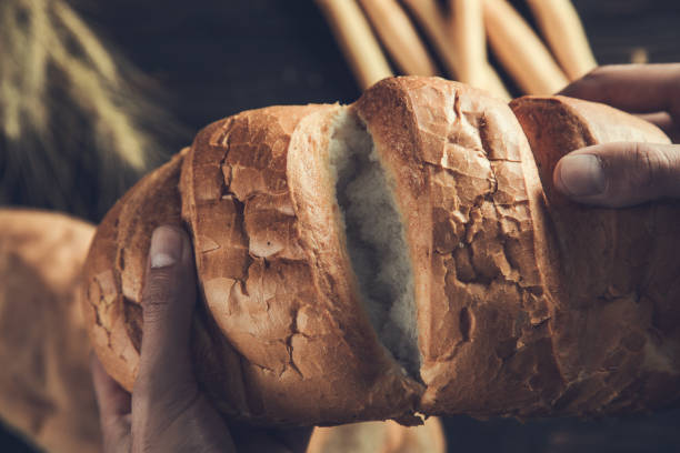 istock Fresh bread in male hands 1289789553