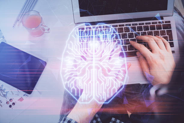 istock Double exposure of man's hands typing over computer keyboard and brain hologram drawing. Top view. Ai and data technology concept. 1289789641