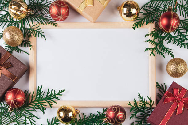 istock Gift boxes and gold festive decor on white background. Mock up for Christmas advertisement. 1289790944