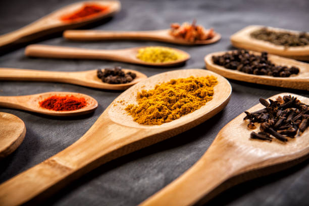 istock Various spice on wooden spoons with herbs 1289791843