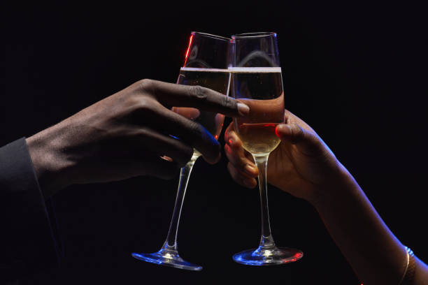 istock African-American Couple Clinking Glasses in Dark 1289792761