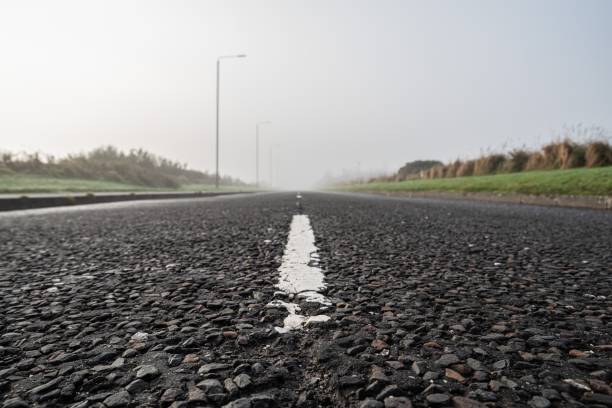 istock Road and its markings stretching into the distance 1289793823