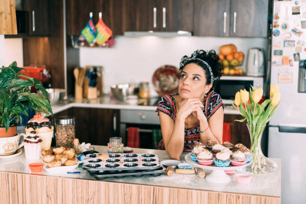 istock Housewife standing alone in the kitchen and dreaming 1289797799