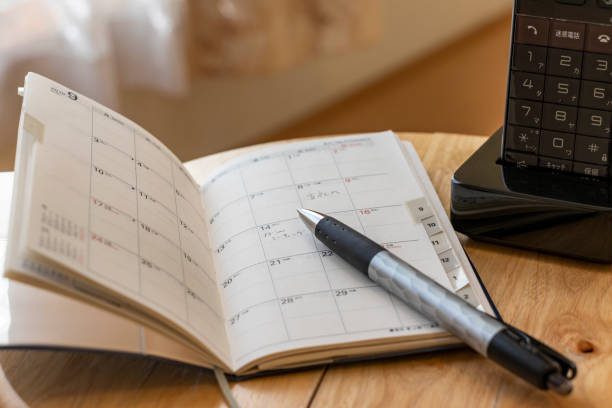 notebook and phone placed by the window - writing instrument imagens e fotografias de stock