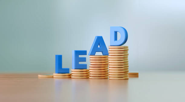 istock Blue Letters Sitting On Coin Stacks Writes Lead Before Defocused Background 1289801814