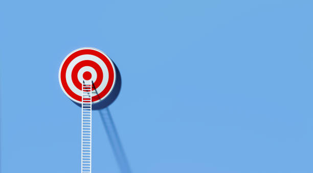 istock White Ladder Leaning on A Target on Blue Wall 1289803196