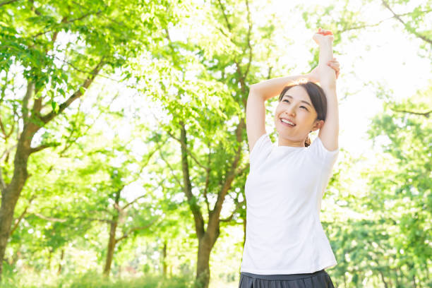 istock asian woman exercising in the park 1289803313