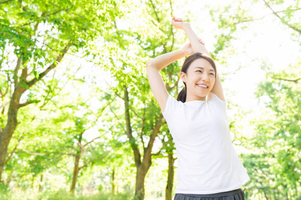 istock asian woman exercising in the park 1289803318
