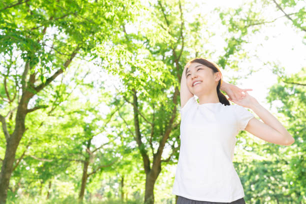 istock asian woman exercising in the park 1289803322