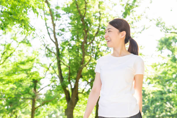 istock asian woman exercising in the park 1289803334