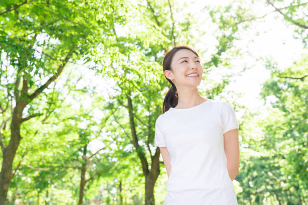 istock asian woman exercising in the park 1289803338
