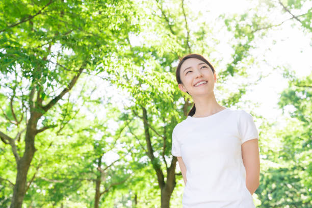 istock asian woman exercising in the park 1289803347