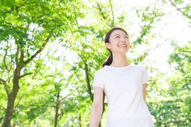 istock asian woman exercising in the park 1289803357