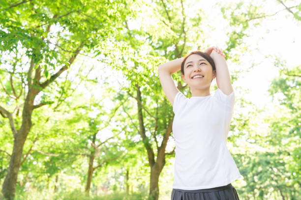 istock asian woman exercising in the park 1289803378