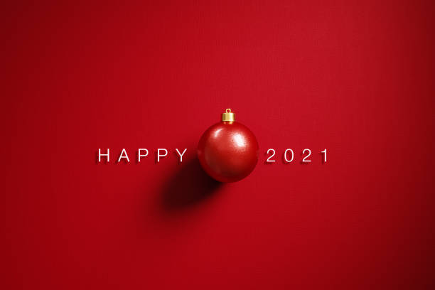 istock Christmas Concept-  Red Bauble and Happy 2021 Message on Red Background 1289804137