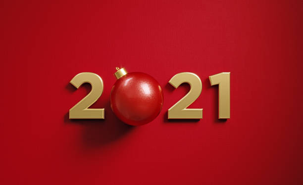 istock Christmas Concept-  Red Bauble Sitting Between 2021 Numbers on Red Background 1289804171