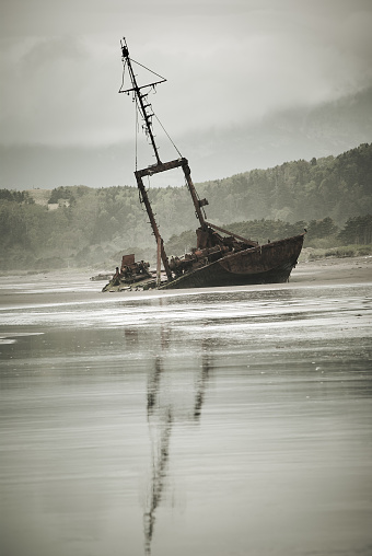 Old shipwreck about coast of Kunashir island, Kurils islands, gloomy weather