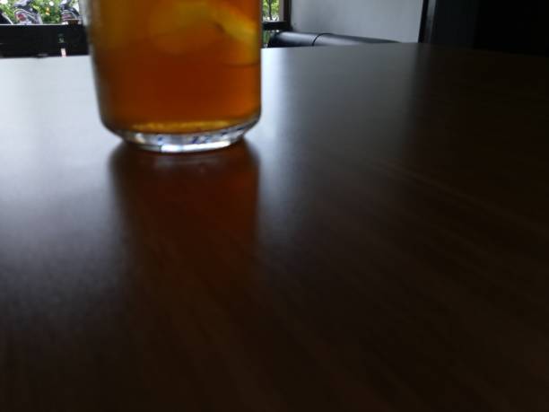 istock Dark background and part a glass of lemon tea ice 1289811882