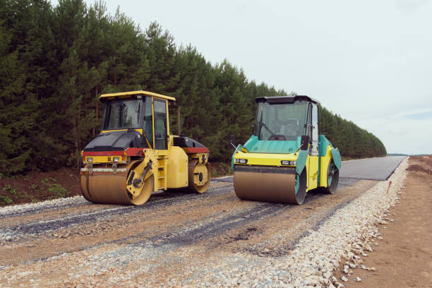 istock Special road vehicles. Compactor At Road Compaction Works. A roller compacting asphalt on a road 1289812145