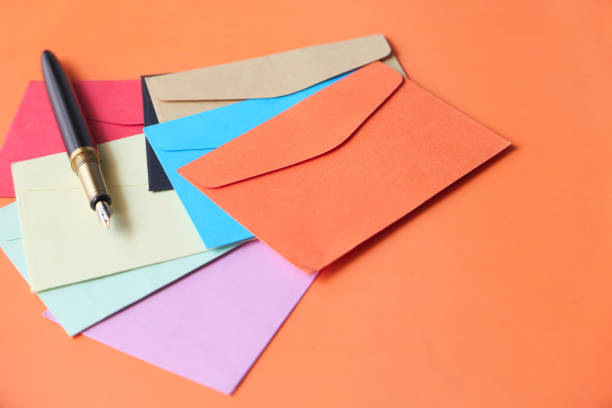 istock colorful envelopes and fountain pen on orange background 1289814785