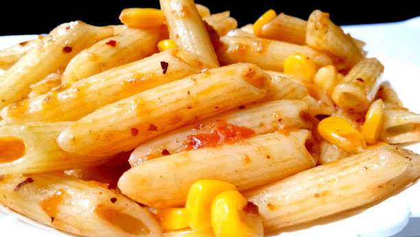 istock Closup of penne pasta with tomato sauce 1289814950