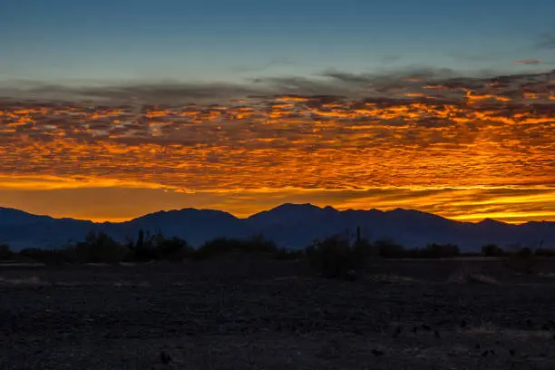 Sunset over a colorful cloudscape in twilight in the desert