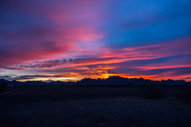 Sunset over a colorful cloudscape in twilight in the desert
