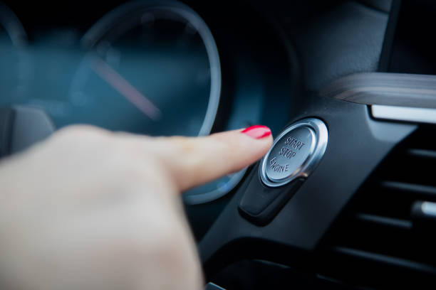 istock female finger presses the start stop engine button on a car dashboard. close-up, soft focus, in the background the dashboard and car speedometer in blur, side view 1289817940