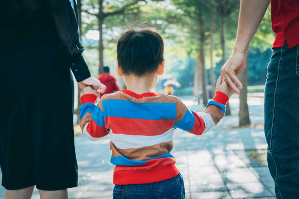 istock Parents play with kid outdoor 1289818857