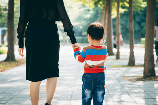 istock Parents play with kid outdoor 1289818905