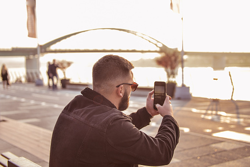 Man photographing with smart phone