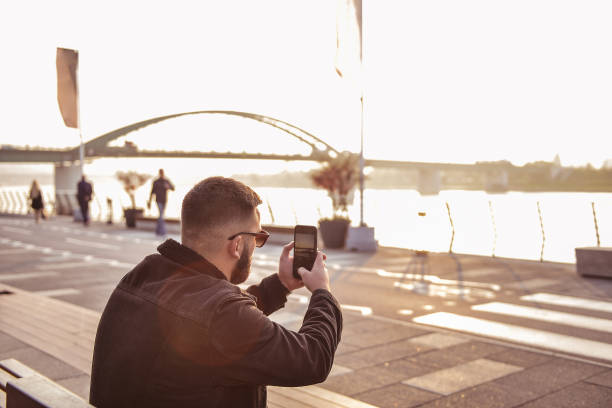istock Man photographing with smart phone 1289821460