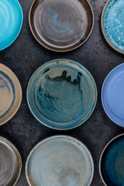 istock abstract background with many decorative empty round ceramic dishes of different colors. handmade dishware and retro template 1289821639