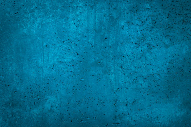 istock Beautiful blue color grunge background with copy space, abstract stucco wall texture with holes and scuffs 1289821643