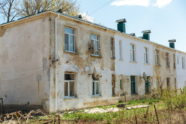 istock Old dilapidated, weather-beaten house that needs to be renovated. Housing problem 1289827261
