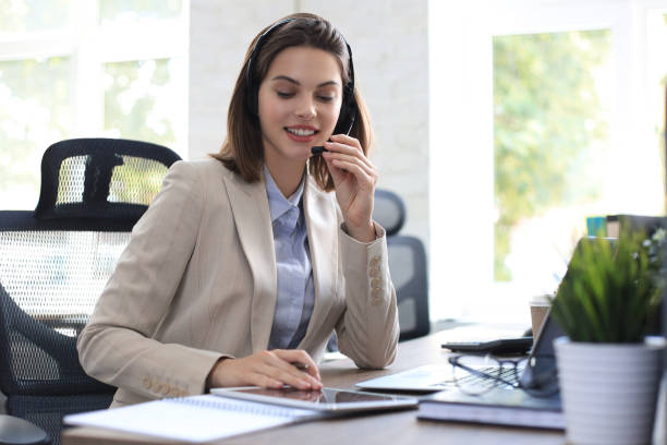 istock Freelance operator talking with headsets and consulting clients from office. 1289830752