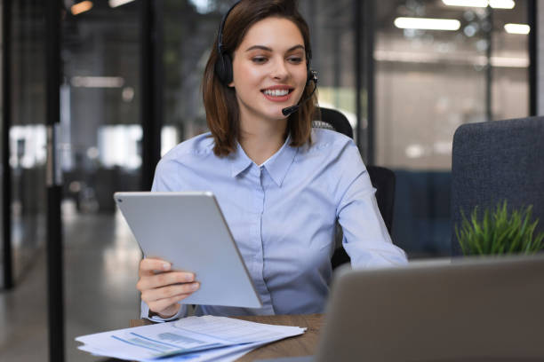 istock Freelance operator talking with headsets and consulting clients from office. 1289831379