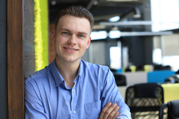 istock Young handsome businessman smiling in an office environment. 1289833746