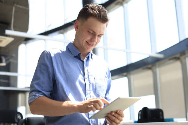 istock Young businessman using his tablet in the office. 1289833783