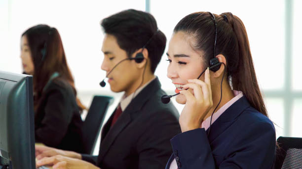 istock Business people wearing headset working in office 1289833942