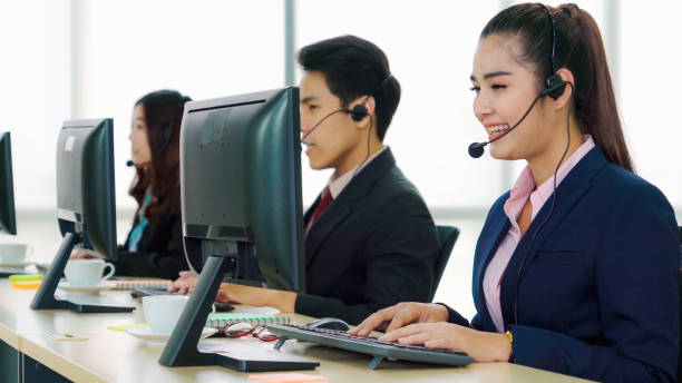 istock Business people wearing headset working in office 1289834134
