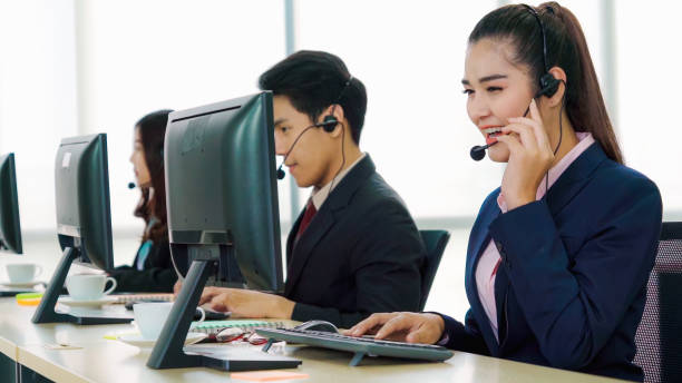 istock Business people wearing headset working in office 1289834294