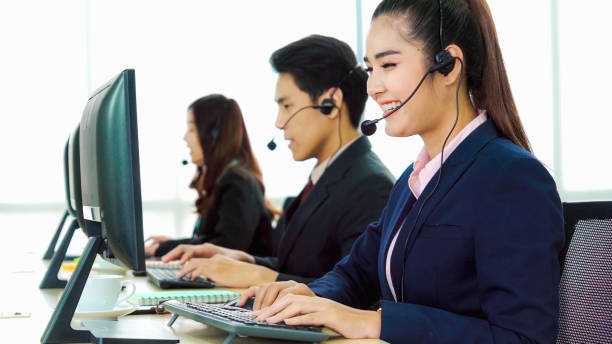 istock Business people wearing headset working in office 1289835331