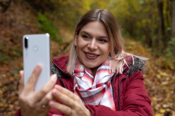 istock Woman making online content outdoor-autumn 1289835648