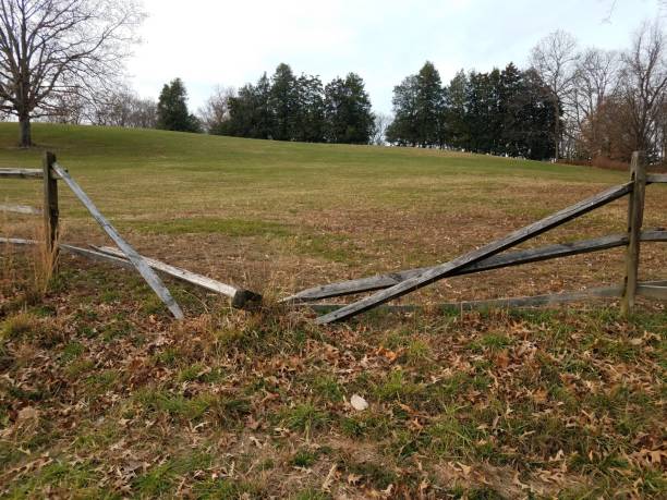 istock broken wood fence with green grass or lawn 1289836647